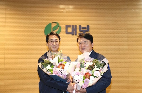 2022년 11월 대보건설 대표이사 이취임식에서 꽃다발을 건네며 서로를 격려하고 있는 김원태(왼쪽), 정광식 전 대표이사 (사진출처. 대보그룹 블로그)